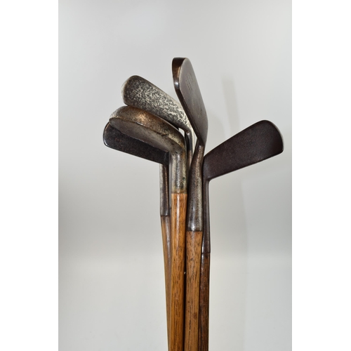 385 - Selection of 7 hickory shafted golf clubs to include irons and putters. 5 have leather wrapped handl... 