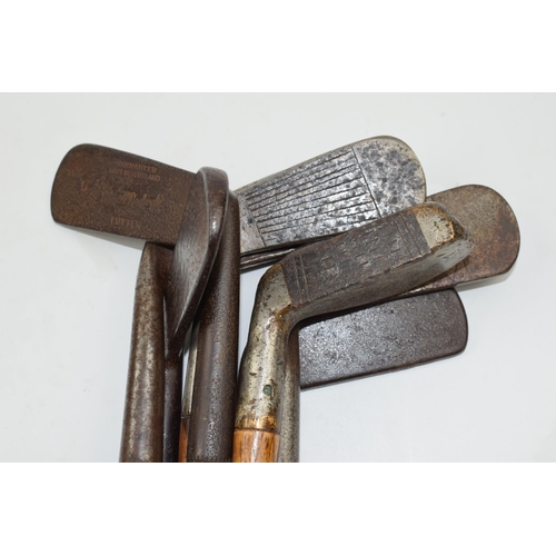 385 - Selection of 7 hickory shafted golf clubs to include irons and putters. 5 have leather wrapped handl... 