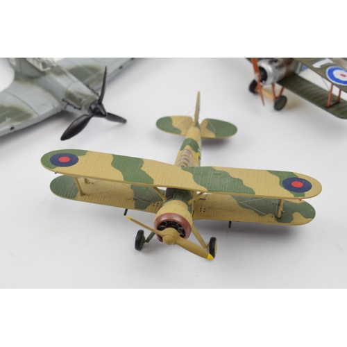 399 - Three model die cast model war planes. Dinky Hawker Hurricane, Corgi Gladiator, Egypt 1940 and a Sop... 