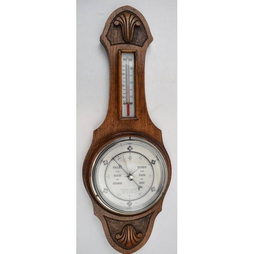 402 - British made barometer and thermometer. Light oak mount and marked 551 to reverse.