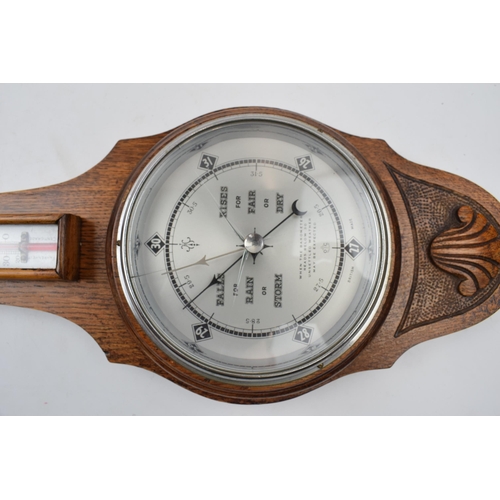 402 - British made barometer and thermometer. Light oak mount and marked 551 to reverse.