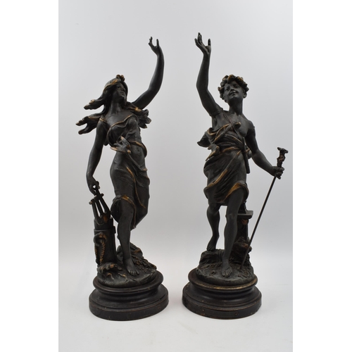 406 - A pair of spelter figures in classical poses. Height 46cm.