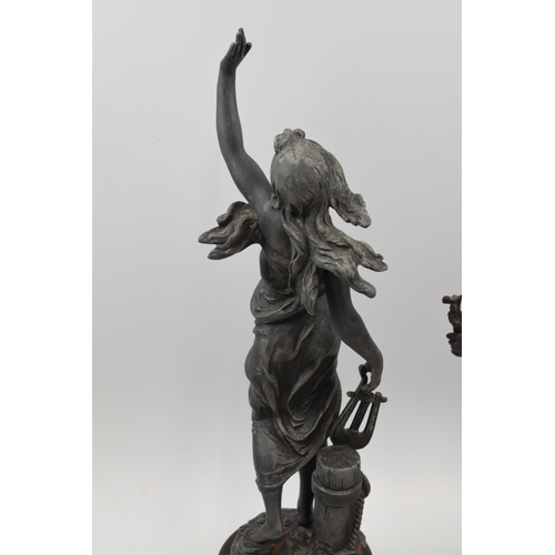 406 - A pair of spelter figures in classical poses. Height 46cm.