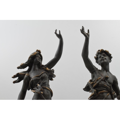 406 - A pair of spelter figures in classical poses. Height 46cm.