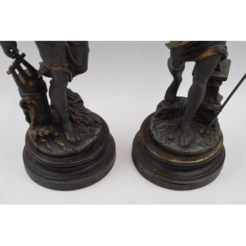 406 - A pair of spelter figures in classical poses. Height 46cm.