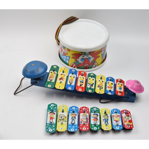 418 - A trio of vintage childrens toys to include a pair of metal xylophones and a drum decorated with clo... 