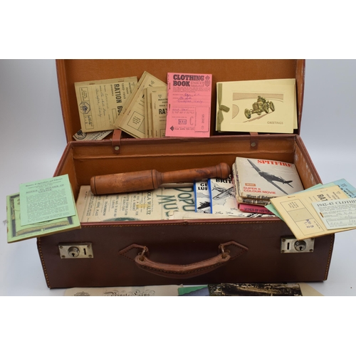 431 - A vintage leather suitcase with contents to include a pair of Georgian style spectacles, postcards t... 