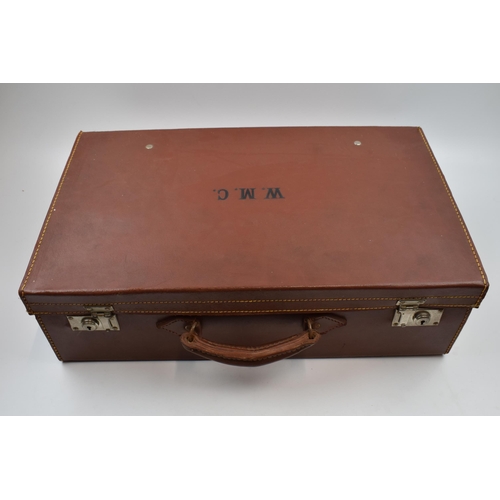 431 - A vintage leather suitcase with contents to include a pair of Georgian style spectacles, postcards t... 