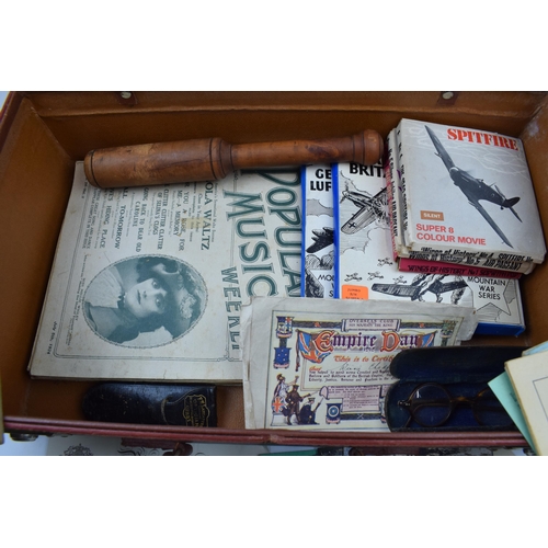 431 - A vintage leather suitcase with contents to include a pair of Georgian style spectacles, postcards t... 