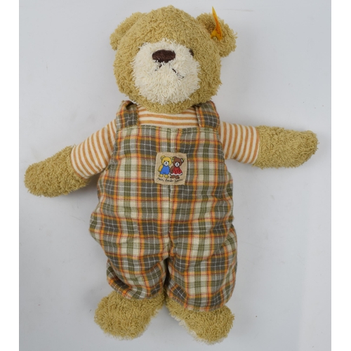 433 - Steiff teddy bear wearing dungarees, 32cm long.