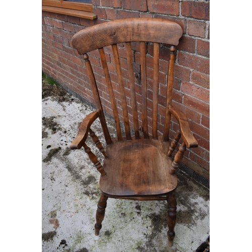 438 - High backed country / farmhouse arm chair with shaped saddle seat, 114cm tall.