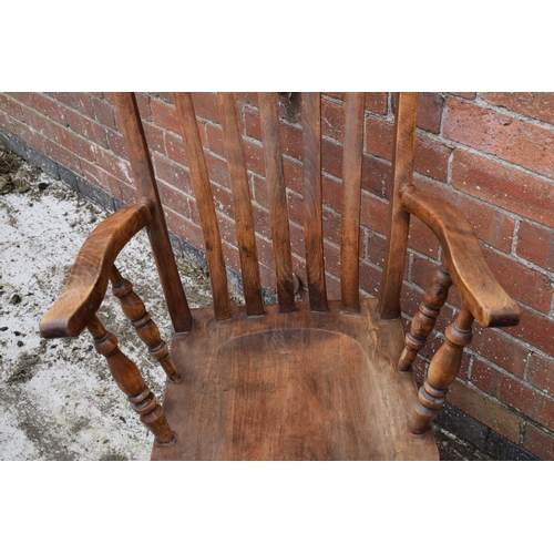 438 - High backed country / farmhouse arm chair with shaped saddle seat, 114cm tall.