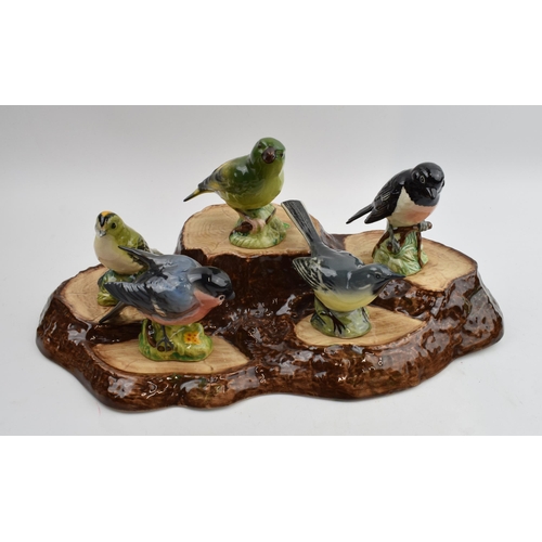 76 - A collection of Beswick birds on a Beswick base, to include, Yellow Wagtail, Bullfinch, Stonechat, G... 