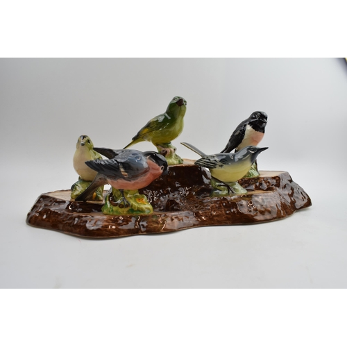 76 - A collection of Beswick birds on a Beswick base, to include, Yellow Wagtail, Bullfinch, Stonechat, G... 