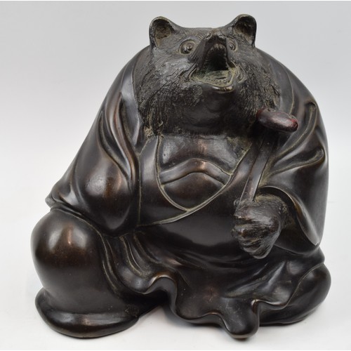 Bronze sculpture of Tanuki the Japanese shape-shifting racoon dog who is said to be able to transform into a buddhist priest. Meiji - Taisho period. Height 24cm Base width 26cm.
