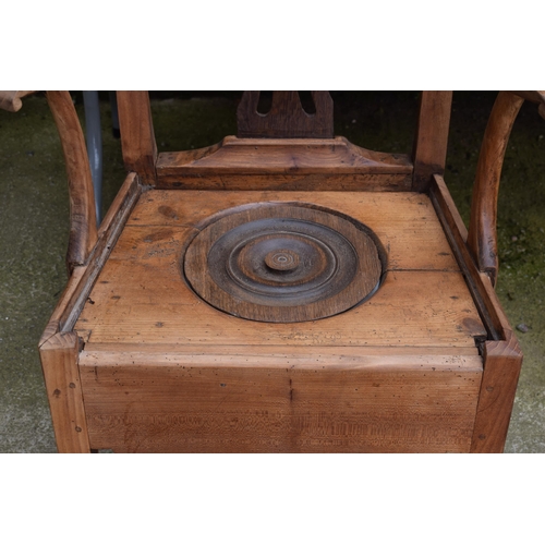 440 - Pine commode chair with ornate back and ceramic liner, 103cm tall.