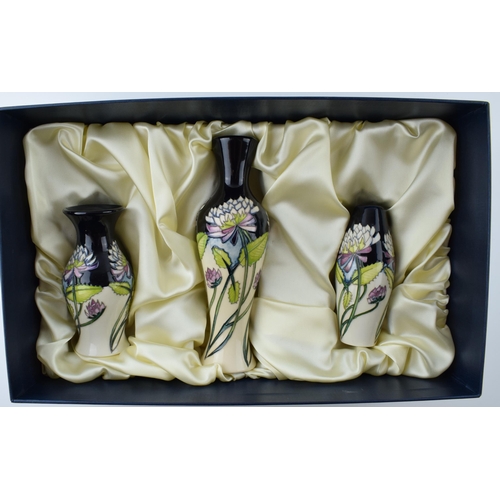 104 - Boxed Moorcroft set of 3 vases in the Trefoil design in presentation box, tallest 20.5cm tall (3).