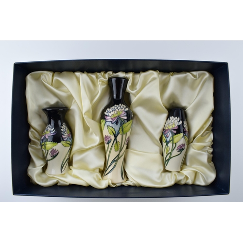 104 - Boxed Moorcroft set of 3 vases in the Trefoil design in presentation box, tallest 20.5cm tall (3).