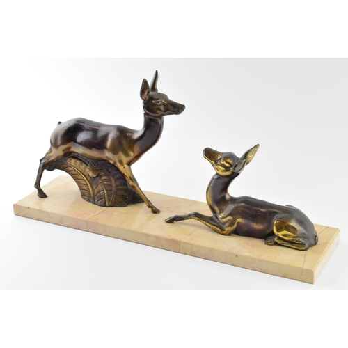 179 - French Art Deco spelter figures of a pair of deers mounted on a marble base, 45cm long.