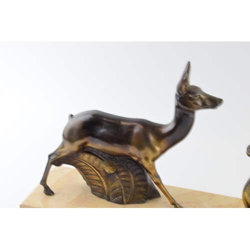 179 - French Art Deco spelter figures of a pair of deers mounted on a marble base, 45cm long.