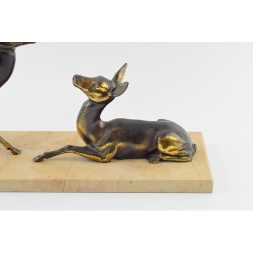 179 - French Art Deco spelter figures of a pair of deers mounted on a marble base, 45cm long.