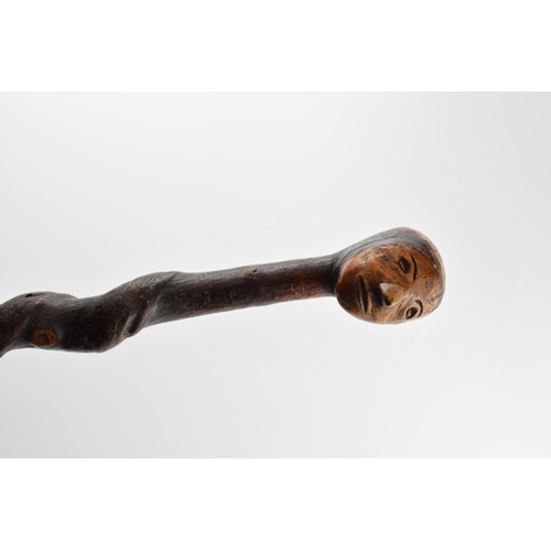 181 - Early 20th century folk art walking stick with carved figural head, 89cm tall.