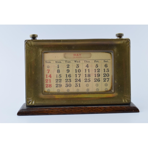 192 - 1930s brass fronted perpetual calendar complete with month and date cards with working scroll.