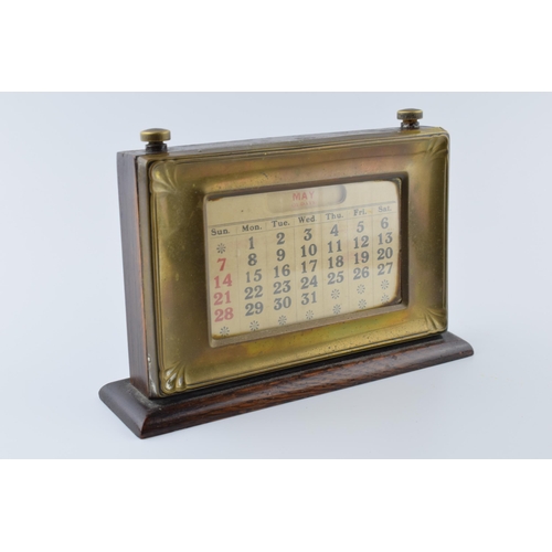 192 - 1930s brass fronted perpetual calendar complete with month and date cards with working scroll.