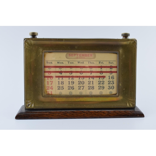 192 - 1930s brass fronted perpetual calendar complete with month and date cards with working scroll.