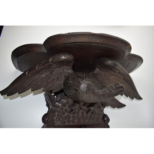 195 - Large Black Forest carved shelf with an eagle amongst foliage, 56cm long.