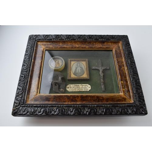 197 - Framed Memento Mori containing lock of hair, carved wooden skull, crucifix, and plaque that reads 