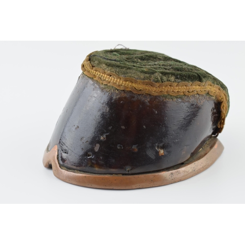 272 - Victorian taxidermy horse's hoof pin cushion with brass shoe and velvet cushion, 14cm long.