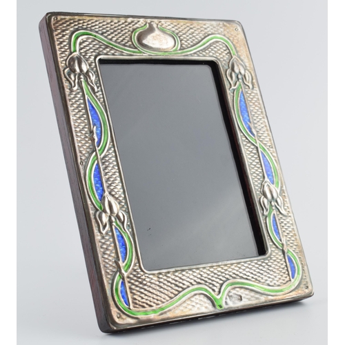 453 - Sterling silver fronted photo frame with enamelled decoration in the Art Nouveau style, 19.5cm tall.