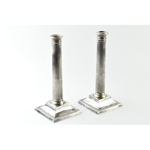 456 - A pair of 26cm tall silver Corinthian column candlesticks, Birmingham 1908, with loaded bases, gross... 