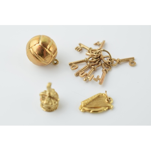 550 - 9ct gold bracelet charms to include a football, a harp / lyre, a crown and a set of keys 'I LOVE YOU... 