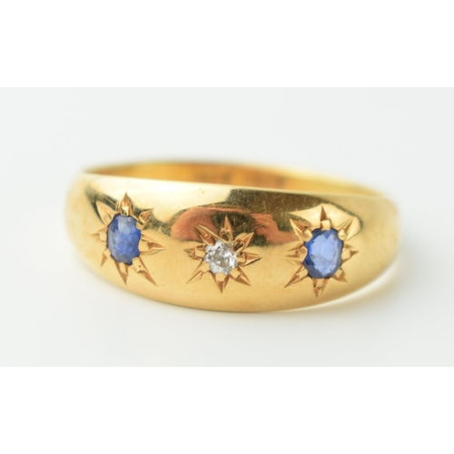 558 - Ladies 18ct gypsy ring with sapphires and diamond. Ring size P. Weight 4g.