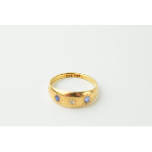 558 - Ladies 18ct gypsy ring with sapphires and diamond. Ring size P. Weight 4g.