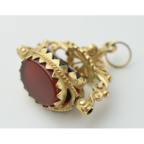 563 - 9ct gold three stone swivel watch fob set with onyx,  carnelian and jade (or similar), 6.0 grams, 26... 