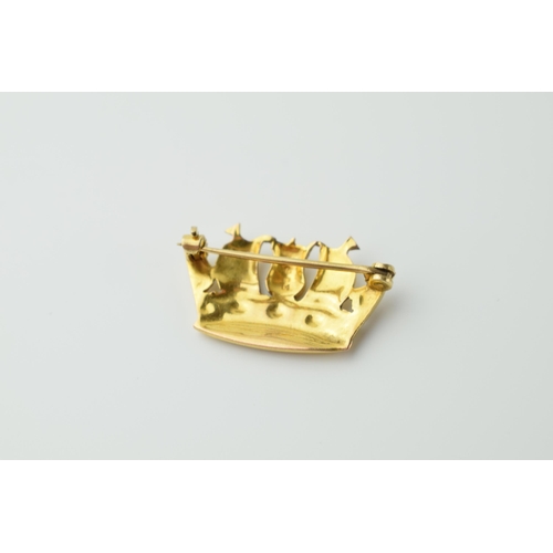 565 - 9ct gold brooch in the form of a royal crown formed with galleons, 2.5 grams, 25mm wide.