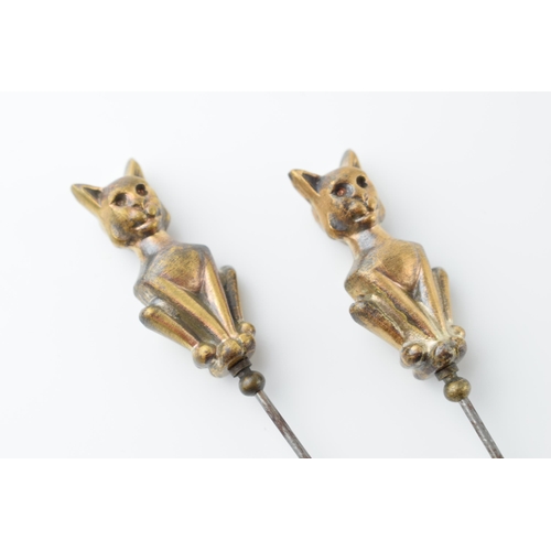 569 - A pair of vintage brass and steel cat hat pins (2), 22cm long.