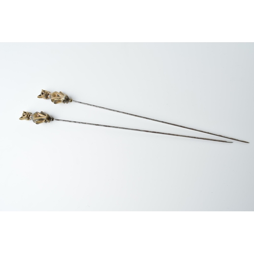 569 - A pair of vintage brass and steel cat hat pins (2), 22cm long.