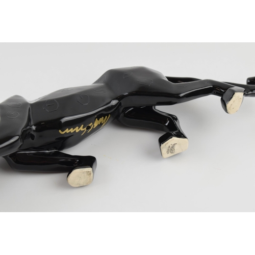 67 - Anita Harris model of a black panther stalking, signed in gold, 43cm long.