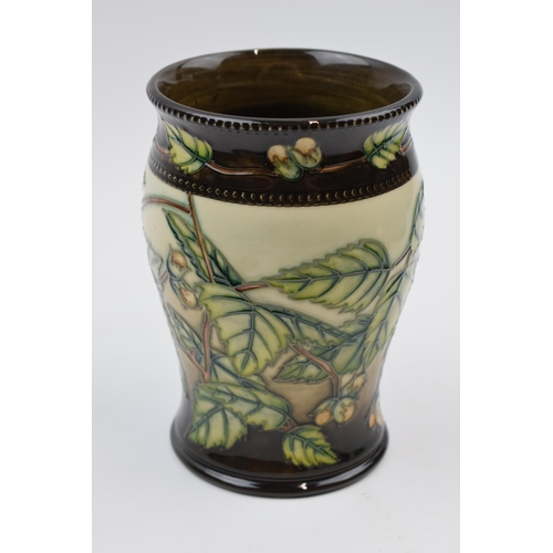 91 - Boxed Moorcroft trial vase decorated with leaf and berries design with brown shaded background, by A... 