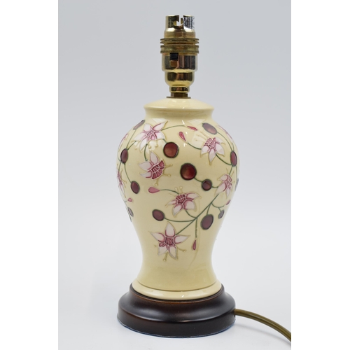 94 - Moorcroft lamp in the Tembusu pattern mounted onto wooden base, 27cm tall inc fittings.