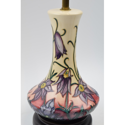 95 - Moorcroft lamp in the Pasque pattern mounted onto wooden base, 31.5cm tall inc brass fittings.