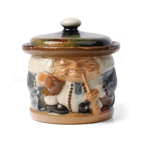 125 - Doulton Lambeth tobacco jar & cover as a toby jug by Harry Simeon, 15cm tall.