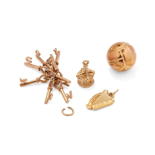 550 - 9ct gold bracelet charms to include a football, a harp / lyre, a crown and a set of keys 'I LOVE YOU... 