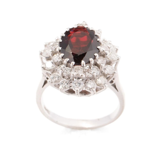 634 - 18ct white gold ring set with 1.25ct of diamond with large garnet stone, 7.7 grams, size O.