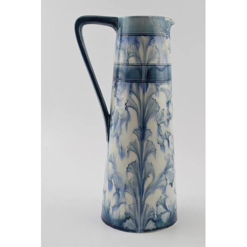 110 - Early Moorcroft blue and white Florian pitcher, 28cm tall (restoration project).