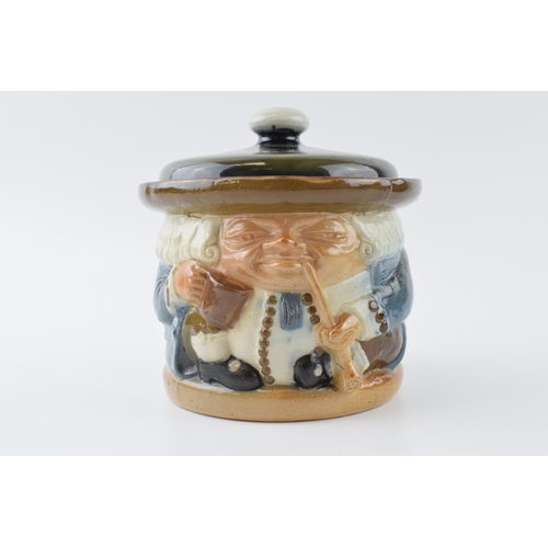 125 - Doulton Lambeth tobacco jar & cover as a toby jug by Harry Simeon, 15cm tall.